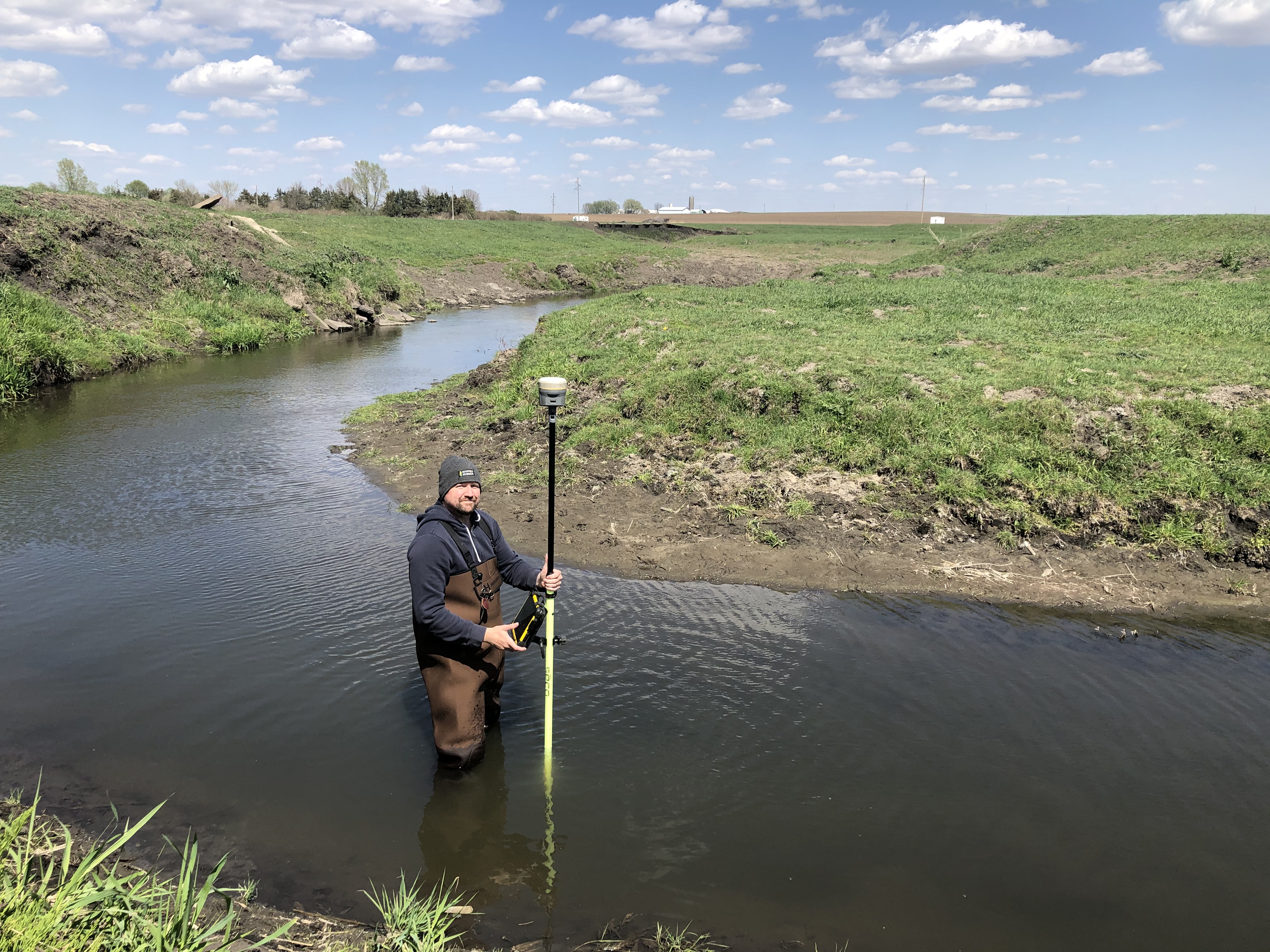 man standing in Iowa stream