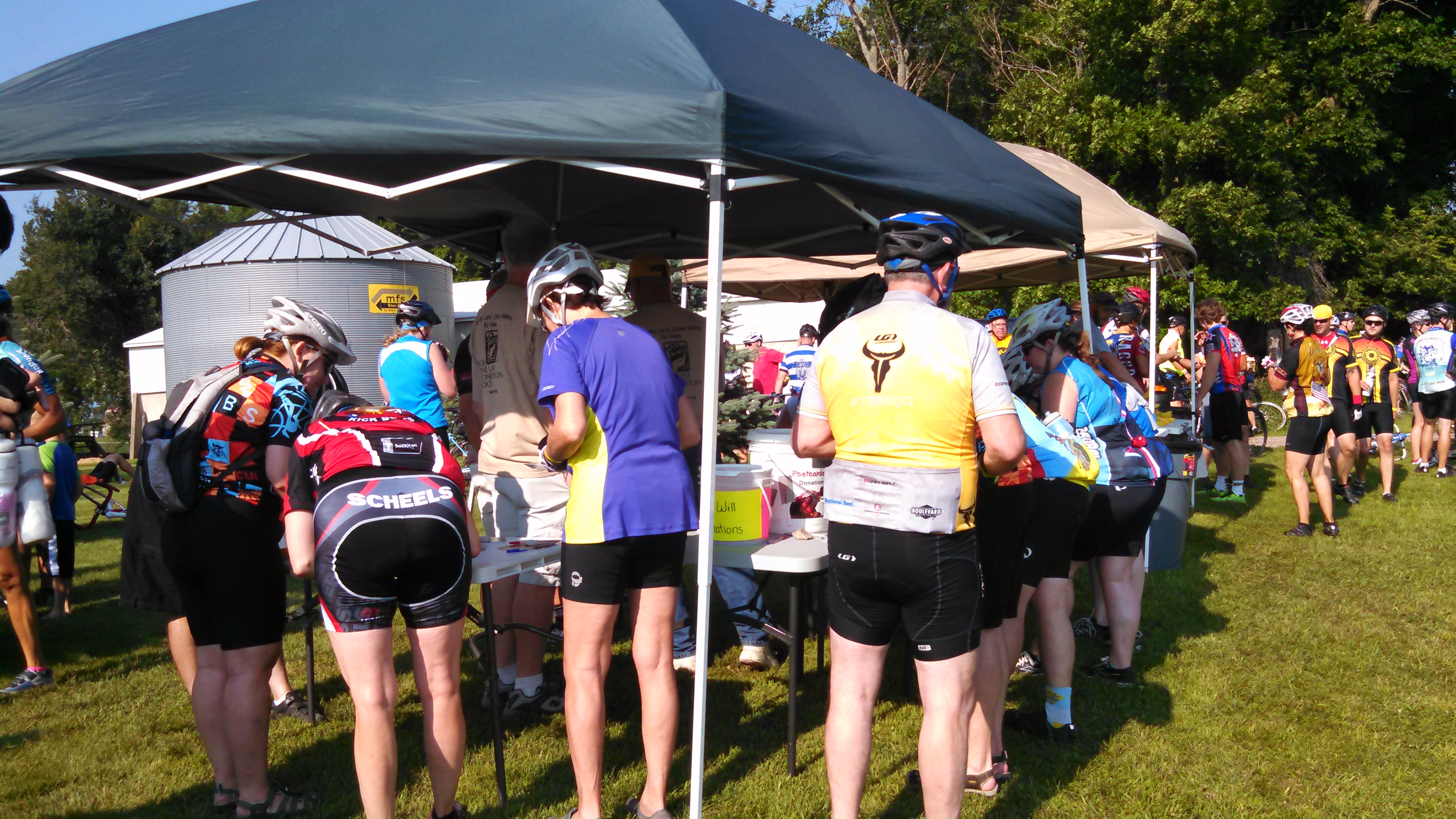 bikers near a silo and tent