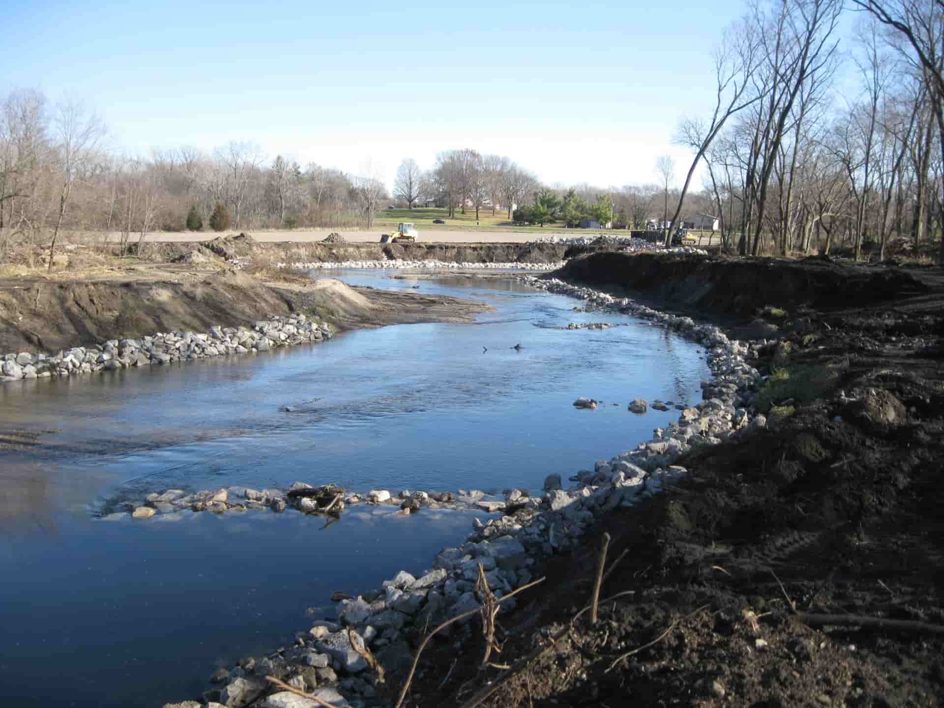 Stream buffer nearly completed with rocks lining the sides