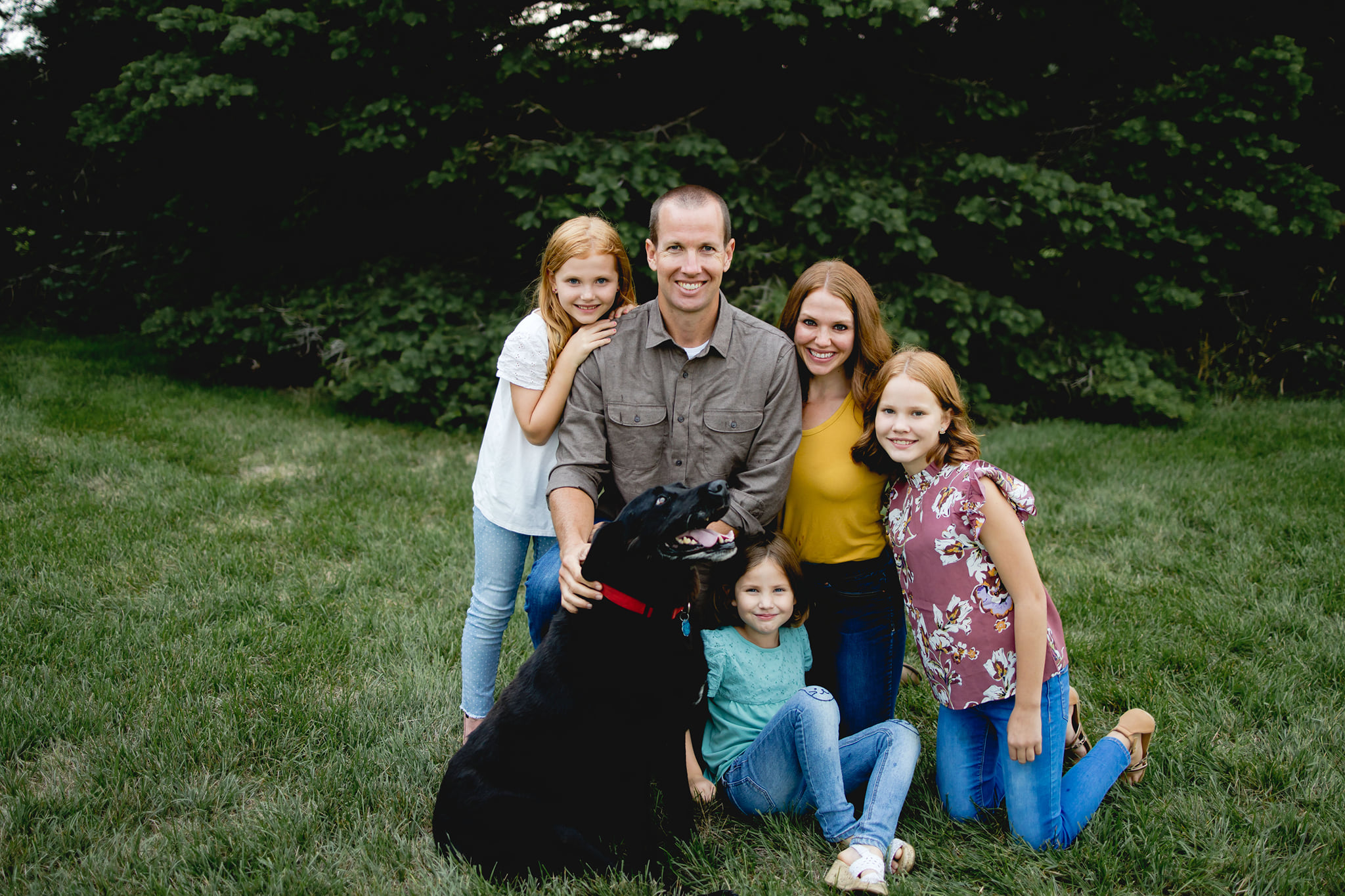 Family photo- father, mother, three daughters, and dog