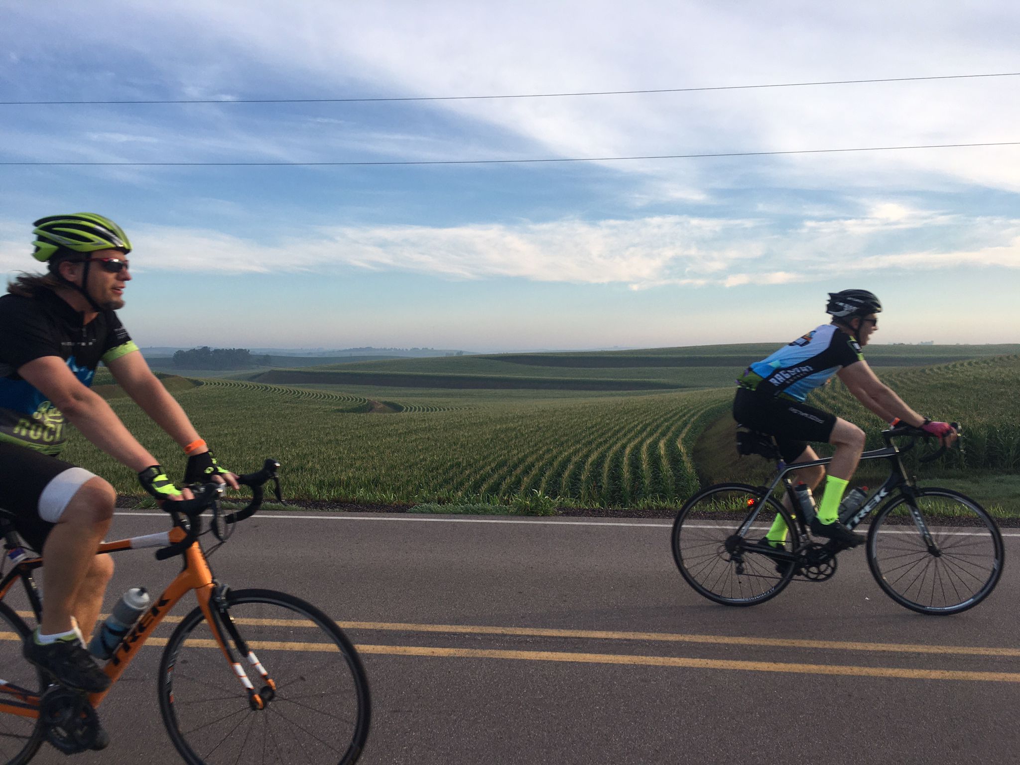 bike riders in front of field