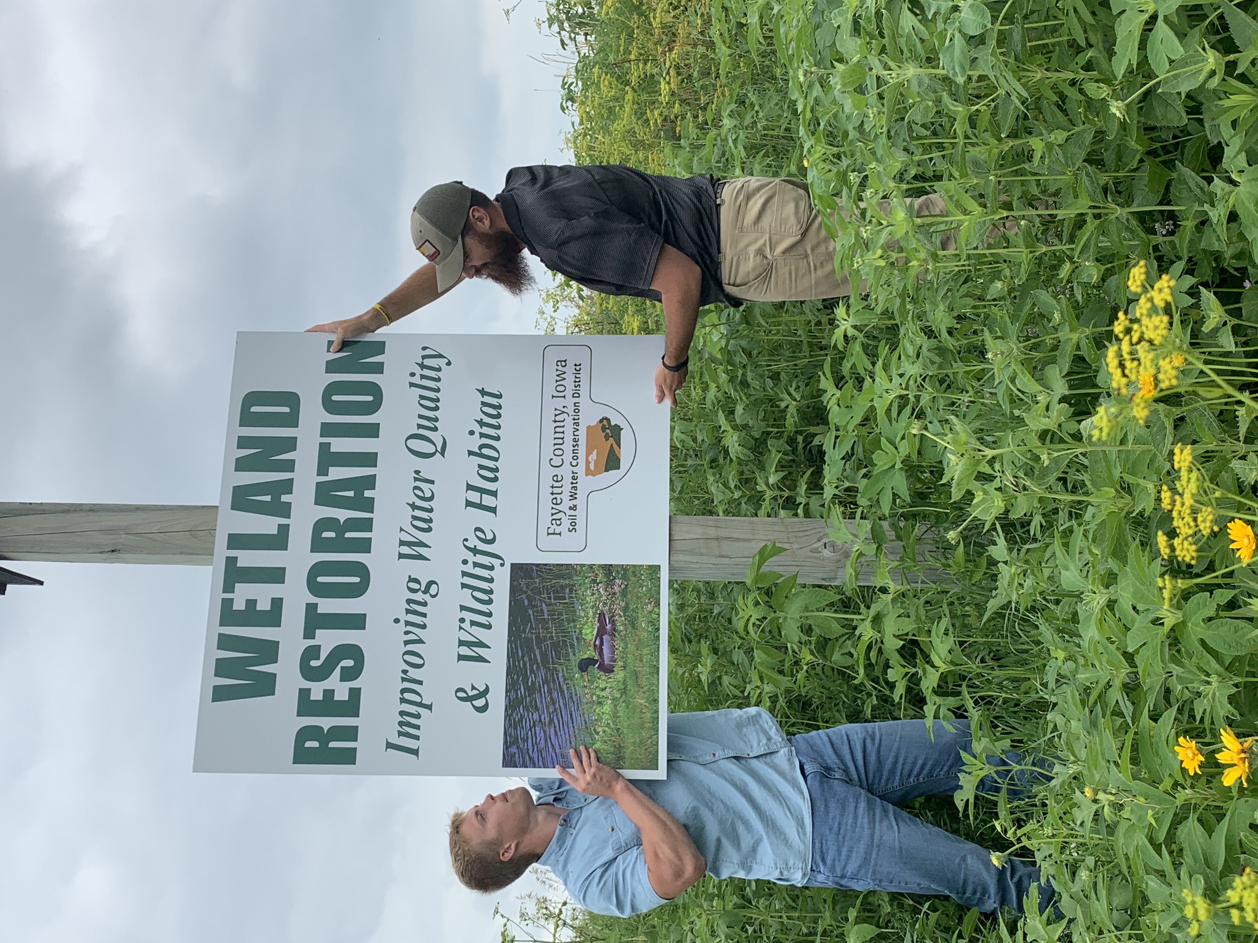 two men hang sign